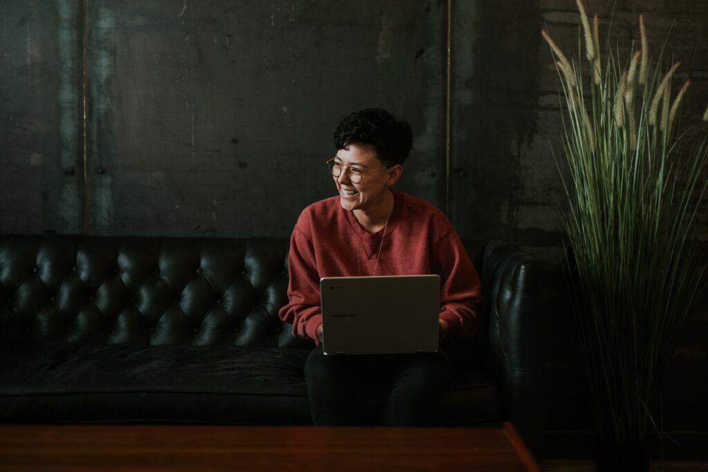 Person holding a laptop on hand